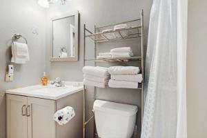 a bathroom with a white toilet and a sink at Sea Treasures Inn #102 in Rockaway Beach