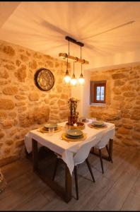 a dining room with a table and a clock on the wall at Casa Martinho & Neves in Seia +13 photos