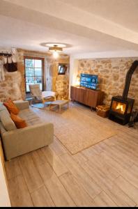 a living room with a couch and a fireplace at Casa Martinho & Neves in Seia
