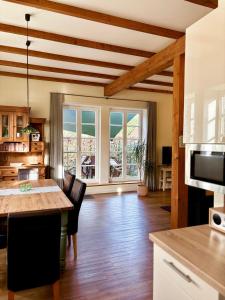 a living room with a table and a kitchen with a view at Ferienwohnung Gänhauk 16 in Löningen