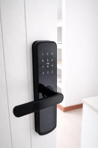 a black remote control is attached to a door at Hotel Boutique Ses Penyes in Alaior
