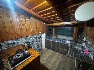 a small kitchen with a sink and a counter top at Peaceful Mountain Cottage in Bhīm Tāl
