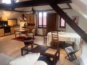 a kitchen and living room with a table and chairs at Escapade Romantique, Salon cathédrale, Strasbourg in Schiltigheim