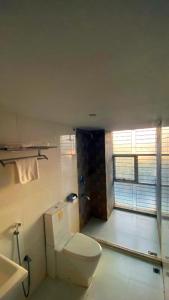 a bathroom with a toilet and a sink at Sylhet La Vista in Sylhet