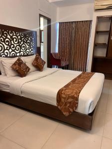 a bedroom with a large bed in a room at Sylhet La Vista in Sylhet