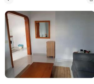 a living room with a mirror and a couch at Apartamentos Punta Mujeres alto derecha in Punta Mujeres
