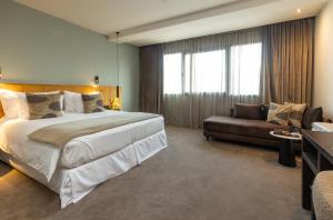 a hotel room with a large bed and a couch at JM Suites Hotel Eco-Friendly Casablanca in Casablanca +171 photos