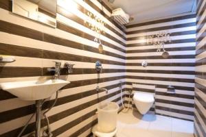a bathroom with a sink and a toilet at Hotel Dream Patna in Patna +32 photos