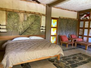 a bedroom with a bed with a painting on the wall at Villas Adriana Wellness Village, Palenque in Palenque +73 photos