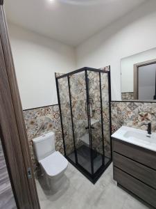 a bathroom with a shower with a toilet and a sink at L'Angolo Felice in Riposto