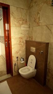 a bathroom with a white toilet in a room at 2bhk corporate home in Sohāna