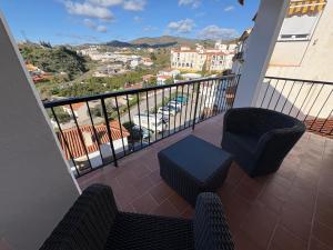 a balcony with a view of a city at Casa Rebeca in Torre de Benagalbón