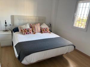 a bedroom with a large bed with pillows on it at Casa Rebeca in Torre de Benagalbón