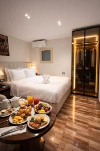 a hotel room with a bed and a table with plates of food at Lotus signature hotel in Cairo