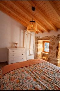 a bedroom with a bed with a dresser and a window at Casa Martinho & Neves in Seia