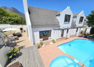 a house with a swimming pool in front of it at The Gables in Hout Bay
