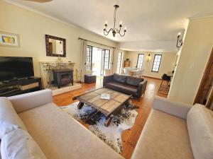 a living room with a couch and a table at The Gables in Hout Bay