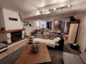 a living room with a couch and a fireplace at Mas de Reilhanette in Montbrun-les-Bains