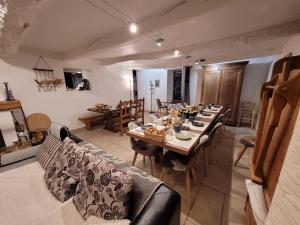 a dining room with a long table and chairs at Mas de Reilhanette in Montbrun-les-Bains