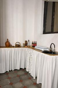 a table with a white table cloth on it at Sweet Home Tskaltubo Family Guesthouse Near Spa Park in Tsqaltubo