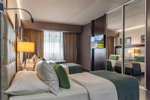 a hotel room with two beds and a bedroom at Lennox Buenos Aires in Buenos Aires