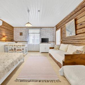 a bedroom with two beds and a kitchen at Wiedemanni Apartments in Haapsalu