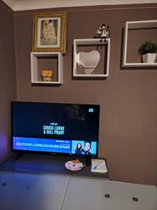 a flat screen tv sitting on top of a dresser at bords de loire in Saint-Sébastien-sur-Loire +8 photos