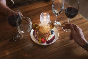 a table with a plate of food and wine glasses at Lennox Buenos Aires in Buenos Aires +28 photos