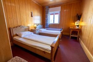 a room with two beds in a wooden room at Villaggio Hotel Aquila in Calliano +286 photos