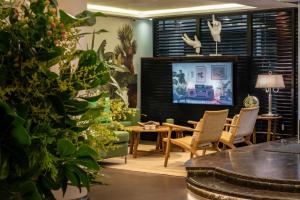 a living room with a tv and a table and chairs at Lennox Buenos Aires in Buenos Aires