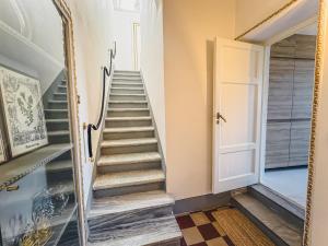 a staircase in a house with a mirror at Luxury Apartment in Lucca in Lucca +15 photos