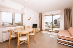 a living room with a table and a couch at Apartamentos Castellmar in Castelldefels