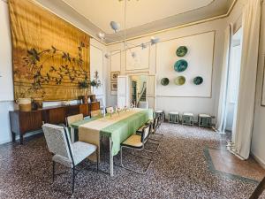 a dining room with a green table and chairs at Luxury Apartment in Lucca in Lucca
