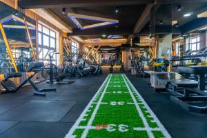 a gym with a green floor in the middle at Express Living & Wellness in Jinja