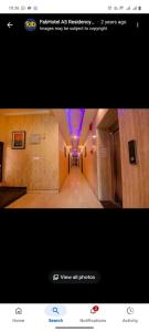 a picture of a hallway with purple lights in a building at As Residency in Dehradun