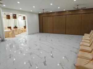 a lobby with a white marble floor and wooden cabinets at As Residency in Dehradun +6 photos