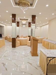 a banquet hall with tables and chairs and a podium at As Residency in Dehradun
