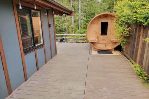 a large wooden boat sitting on the side of a house at Explorer's Retreat Sauna & Bunkhouse & Fire pit in Port Renfrew