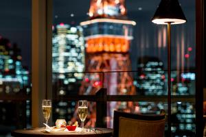 a dining room table with a glass of wine at The Prince Park Tower Tokyo in Tokyo