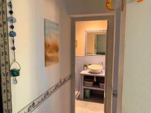 a bathroom with a sink and a mirror at Apartamentos, Edificio Pujolets Es Pujols-Playa in Es Pujols