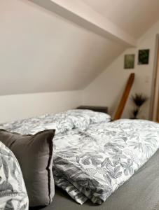 an unmade bed in a bedroom with a pillow at Dachblick by Zirwick Apartment in Windischeschenbach