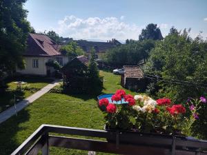 a balcony with a flower box with red and white flowers at Vendel Guesthouse in Mereni