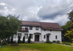 a white house with a balcony on top of it at Vendel Guesthouse in Mereni +25 photos