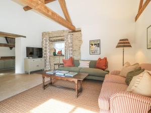 a living room with a couch and a table at The Forge in Stow on the Wold