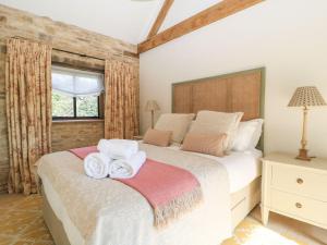 a bedroom with a bed with towels on it at The Forge in Stow on the Wold