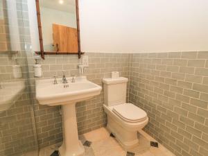 a bathroom with a sink and a toilet and a mirror at The Forge in Stow on the Wold +12 photos