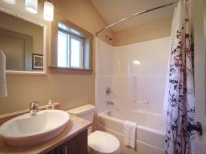 a bathroom with a sink and a toilet and a shower at Hot Tub - Large Fully Enclosed deck - Pet Friendly in Port Renfrew