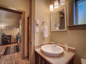 a bathroom with a sink and a mirror at Hot Tub - Large Fully Enclosed deck - Pet Friendly in Port Renfrew