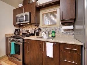 a kitchen with a sink and a stove top oven at Hot tub Oasis Among Trees - Pet Friendly in Port Renfrew