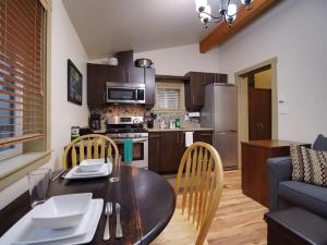 a kitchen with a wooden table and a dining room at Hot tub Oasis Among Trees - Pet Friendly in Port Renfrew